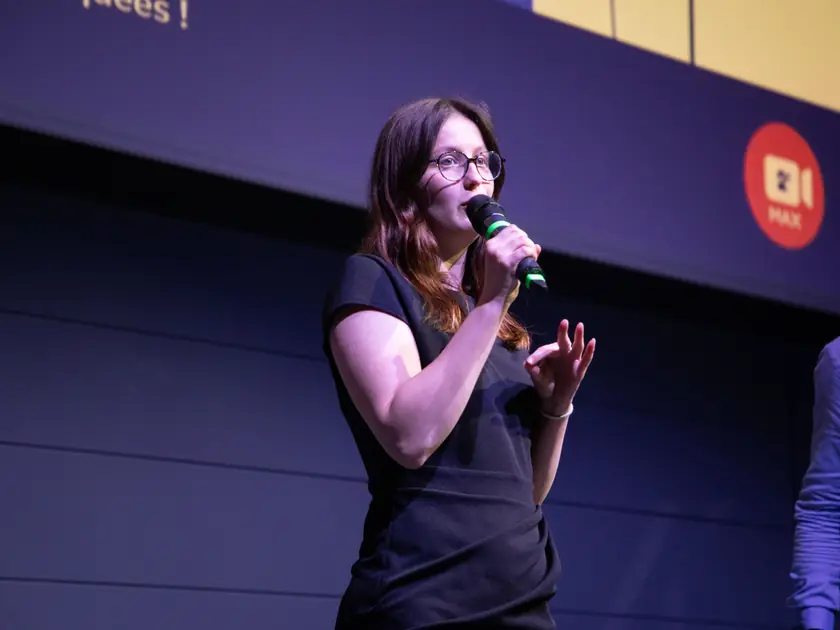 A finalist pitches her project on stage at the final of the 4S competition